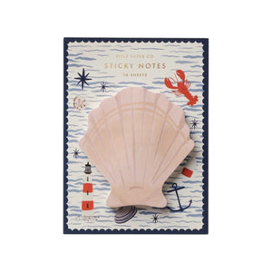 The Seaside Sticky Notes by Rifle Paper Co. are presented on a nautical-themed backing card, featuring delightful illustrations of a lighthouse, anchor, lobster, and rolling waves.