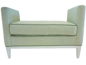 The Lee Ottoman by Lee Industries features a green geometric print, boxy cushion, low arms, and white tapered legs for extra seating, shown against a white background.