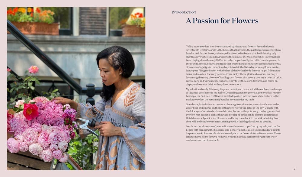 A woman in a patterned dress skillfully arranges pink flowers in a large basket on a city street, holding garden shears as she creates beautiful floral displays. On the right, text introduces “A Sweet Floral Life” from Penguin Random House.