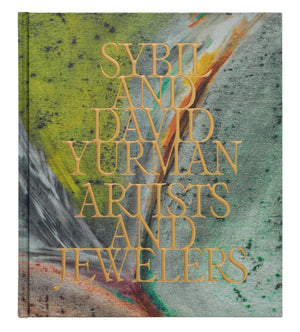 The vibrant book cover, "Sybil and David Yurman: Artists and Jewelers" by Phaidon, stands out against an abstract background, honoring the creative legacy of the renowned fine jewelry brand.