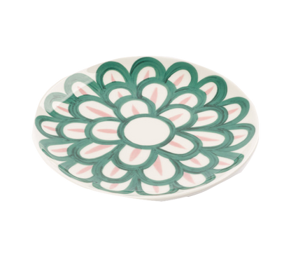 A decorative fine porcelain plate from the Themis Z Symi Green and Pink Collection by Themis Z with a Symi pattern in green and pink on a white background.