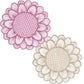 Two round placemats from the Symi Rattan Placemat Collection by Themis Z—one pink, one beige with floral patterns—are handcrafted by Colombian artisans and displayed side by side on a white background.