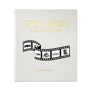 The white cover of "Steven Spielberg: A Retrospective" by Graphic Image features a film strip with logos from Jaws, E.T., Jurassic Park, Schindler’s List, and West Side Story—celebrating Spielberg’s iconic career.