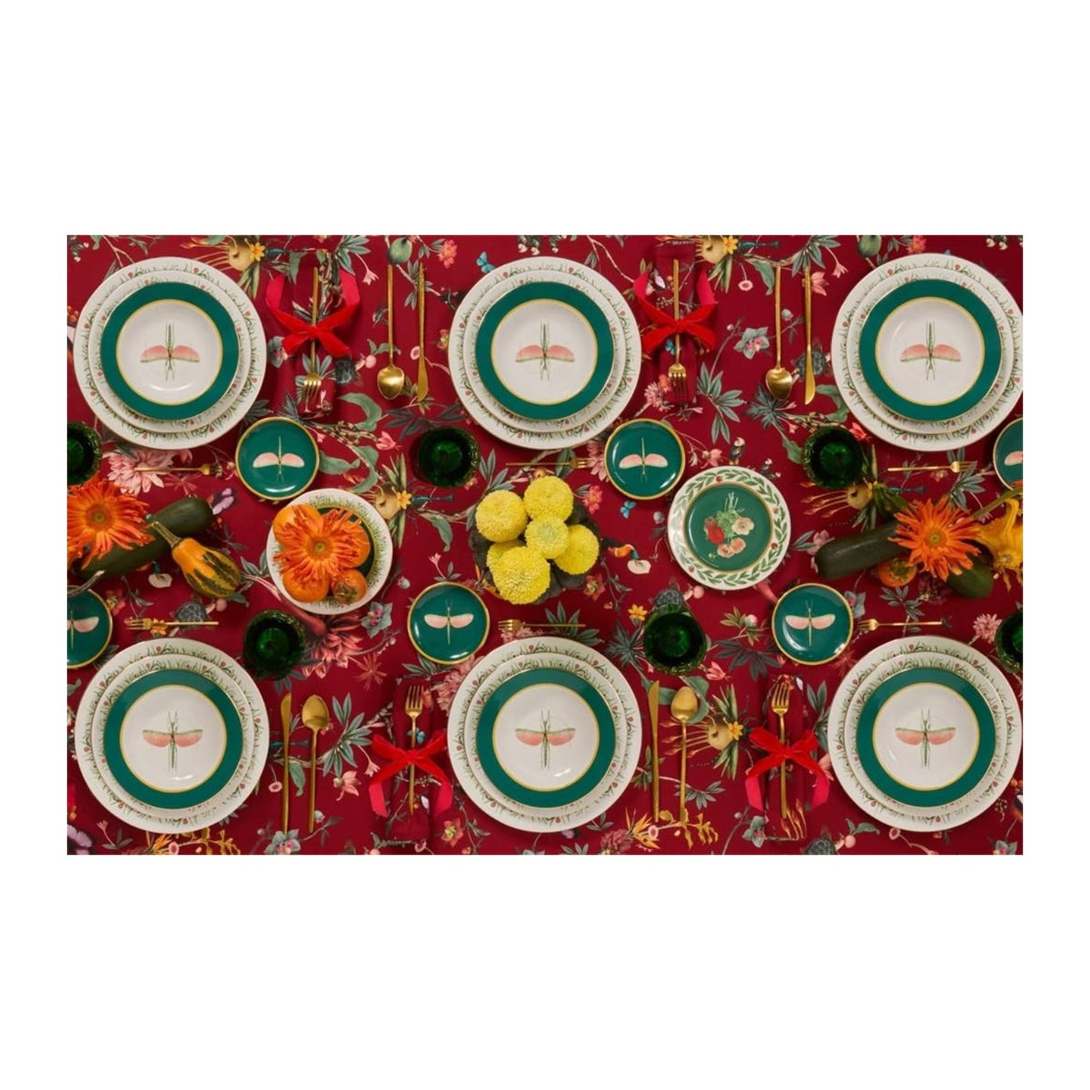 Table Energy: Entertaining with Italian Spirit by Abrams features vibrant red florals, gold utensils, bird plates, flowers, fruit bowls, and red napkins for authentic Italian hospitality.