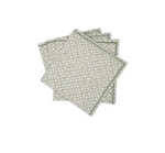 A set of four Laksha napkins by Matouk, stacked slightly askew, each showcasing a green geometric pattern on crisp white in the signature Schumacher style.