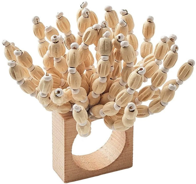 The Kim Seybert Reed Napkin Ring features multiple short wooden dowels, each topped with a small white bead, making it perfect for adding coastal-inspired style to your table setting.