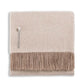 Alicia Adams Alpaca Classic Herringbone Throw Collection: folded beige alpaca blanket with brown fringe and a small label near the edge, fair-trade made in Peru.