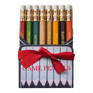The Karen Adams Game Pencil Set features eight sharpened mini pencils with Monopoly-themed words, arranged upright in a box with a red ribbon and labeled "Game Pencils"—perfect for game night.