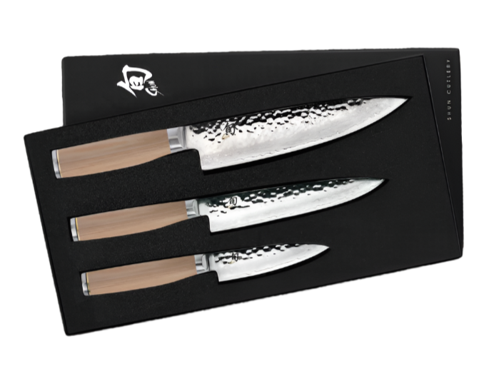 The Shun Premier Blonde Starter Knife Set, 3-Piece, features Japanese knives with VG-MAX cutting cores and wooden handles, elegantly presented in a black foam-slotted box.