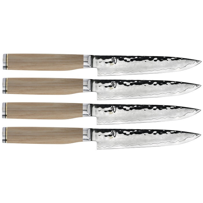 Four identical knives from the Shun Premier Blonde Steak Knife Set, 4-Piece, each featuring a wooden handle and textured stainless steel blades with a VG-MAX cutting core, are aligned horizontally.
