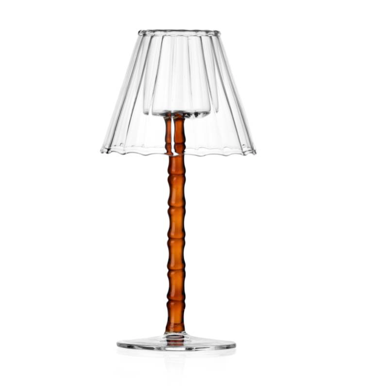 The Rivoli Drinkware and Tealight Collection by Ichendorf Milano features a lamp with a clear glass shade and base, and a textured, amber-colored hand-crafted glassware stem.