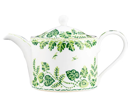 The Cobblers Cove Calypso Dinnerware Collection by Royal Crown Derby features a white ceramic teapot with a round lid and green leaf and vine motifs, evoking a Caribbean feel and pairing perfectly with vibrant green tableware.