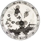 A Ginori 1735 Oriente Italiano Albus plate featuring a black and white floral and landscape design with flowers, leaves, and a patterned border.