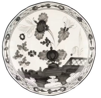 A Ginori 1735 Oriente Italiano Albus plate featuring a black and white floral and landscape design with flowers, leaves, and a patterned border.
