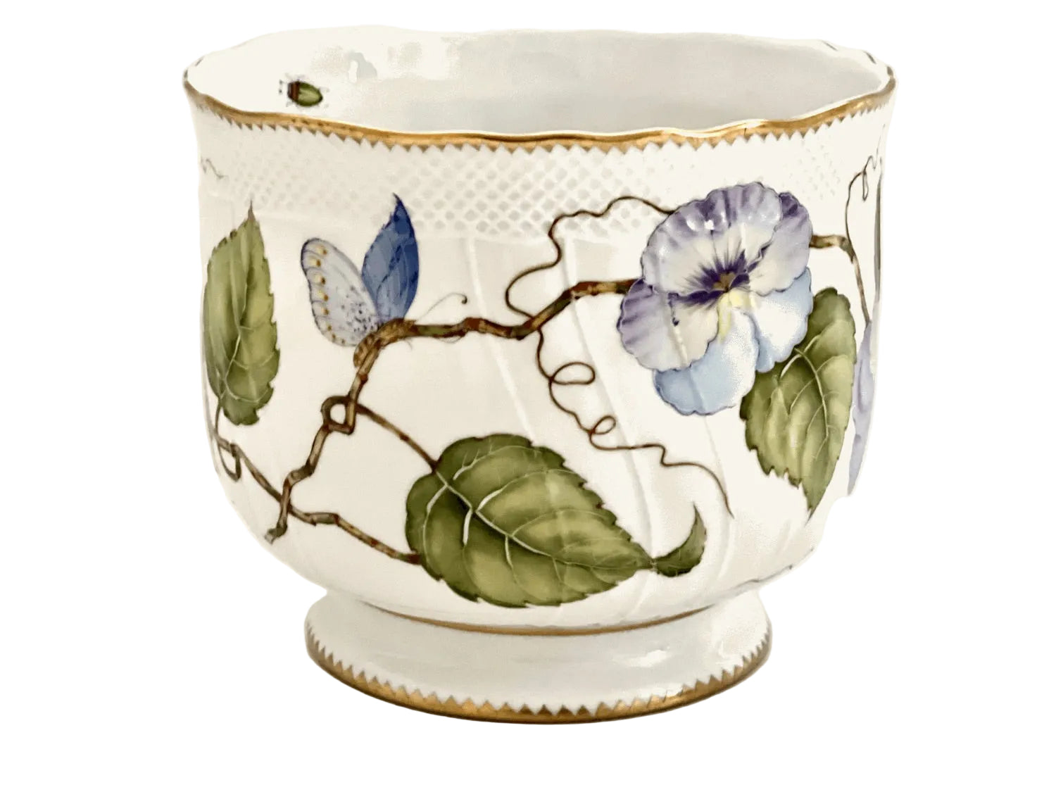 The Pansy Round Cachepot by Anna Weatherley is a white Hungarian porcelain bowl with gold trim, hand painted with green leaves and purple-blue flowers on a vine—ideal as a planter or decorative accent.