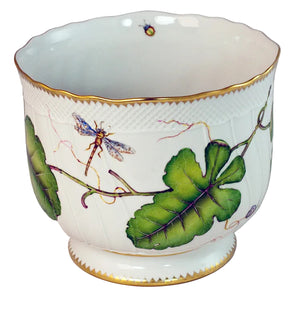 The Anna Weatherley Leaf Cachepot is a white porcelain cachepot with a gold rim, hand painted with green leaves, a dragonfly, and a small insect in exquisite Hungarian style.
