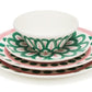 Themis Z Symi Green and Pink Dinnerware Collection: a porcelain set featuring a bowl and three plates, adorned with green and pink floral and polka dot designs.