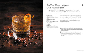 A copy of The Art & Craft of Coffee Cocktails by Simon & Schuster sits on a dark surface, flanked by an orange twist-garnished Coffee Marmalade Old Fashioned, scattered coffee beans, and a metal jigger—perfect inspiration for those eager to explore innovative cocktail recipes.