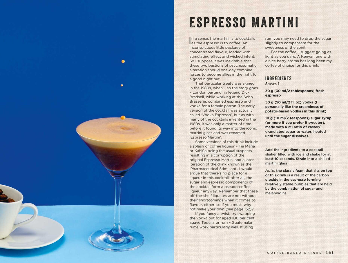 A glass of espresso martini with a foamy top rests on a blue surface next to a small cup of espresso and an open page from Simon & Schuster’s Curious Barista’s Guide To Coffee, providing the ideal setup for discovering coffee essentials and popular espresso drinks.