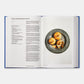 An open copy of *The Jewish Cookbook* by Phaidon highlights a recipe for "Kasha and Mushroom Knishes" on the left page, accompanied by a tempting photo of three knishes displayed on a gray plate on the right.