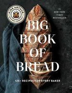 The cover of the King Arthur Baking Company Big Book of Bread, published by Simon & Schuster, showcases a sliced loaf of artisanal sourdough bread on a dark surface with text overlay.