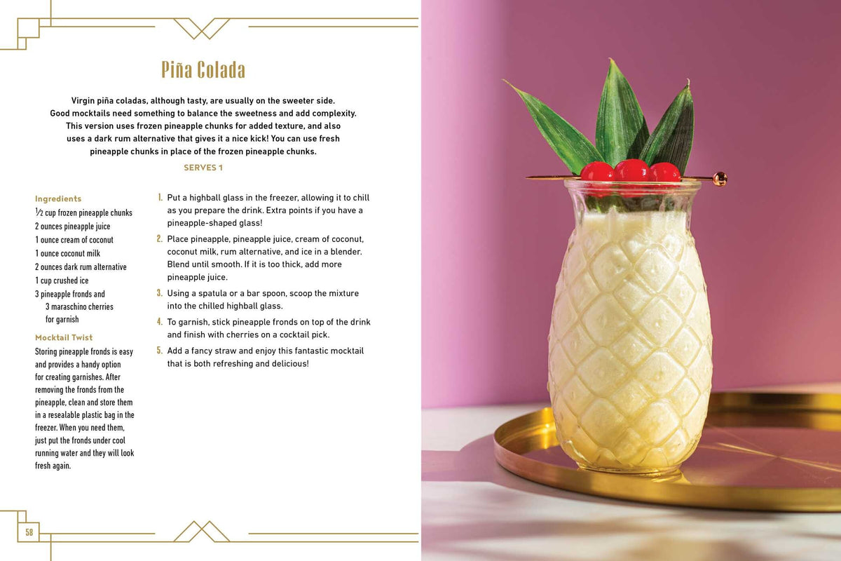 A refreshing Mocktail Club piña colada is served in a pineapple-shaped glass, garnished with leaves and cherries, and placed on a gold tray alongside a Simon & Schuster recipe book featuring delicious alcohol-free cocktails and instructions—all set against a vibrant pink and purple background.