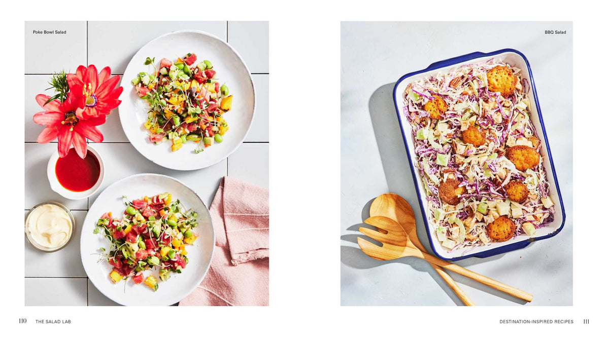 Two white bowls filled with chopped salad from Salad Lab: Whisk, Toss, Enjoy! by Simon & Schuster—taking inspiration from The Salad Lab’s viral TikTok salad recipes—paired with two red drinks on the left; on the right, a tray of coleslaw and fried balls served alongside wooden utensils.