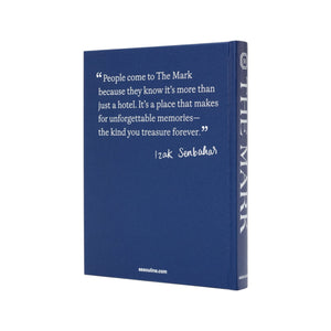 A blue hardcover book titled "The Mark" by Assouline features a quote about the luxury hotel on its cover, attributed to Izak Senbahar.