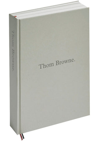 The Phaidon "Thom Browne" hardcover book features a plain light gray cover and ribbon bookmarks—an elegant pick for those intrigued by modern suit design or fashion photography.