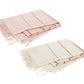 Two folded throws from the Amelia Stripe Throw Collection by Matouk—one in light pink with red stripes, the other in off-white with tan stripes—crafted from baby alpaca, are laid side by side on a white background.