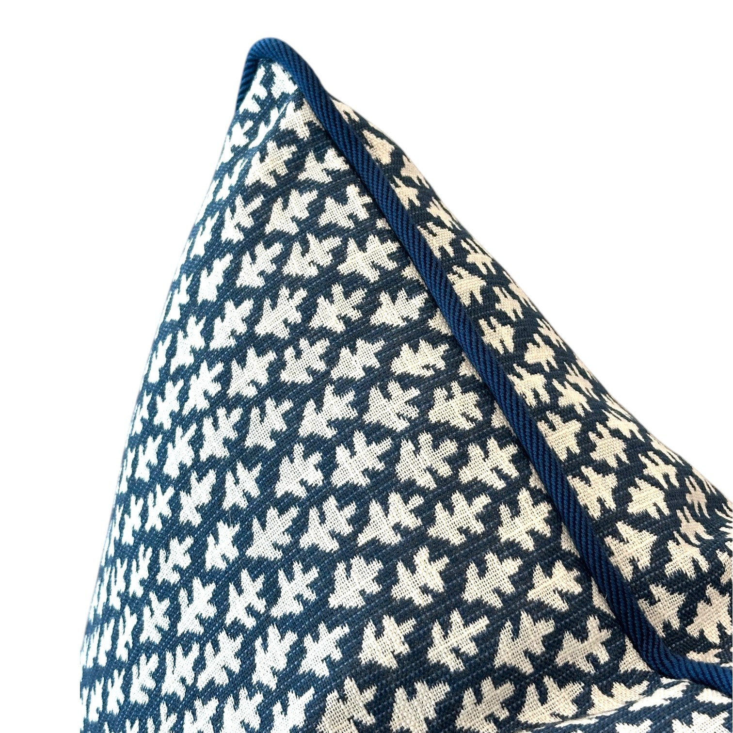 Close-up of the Burma Indigo Outdoor Pillow by Associated Design, featuring a navy blue and white pattern with blue piped edges, expertly crafted from premium materials, displayed against a white background.