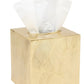 The Pigeon & Poodle Mancora Bath Collection gold-colored tissue box features a textured leaf pattern and shiny finish, with white tissues visible through the top opening.