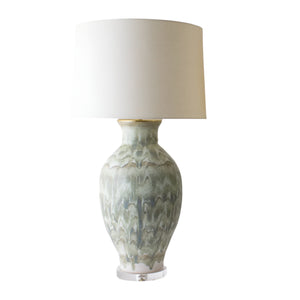 The Matagorda Lamp in Green Drip by Paul Schneider Ceramics features a textured ceramic base with artistic green glazing and a large white fabric shade, shown against a white background.