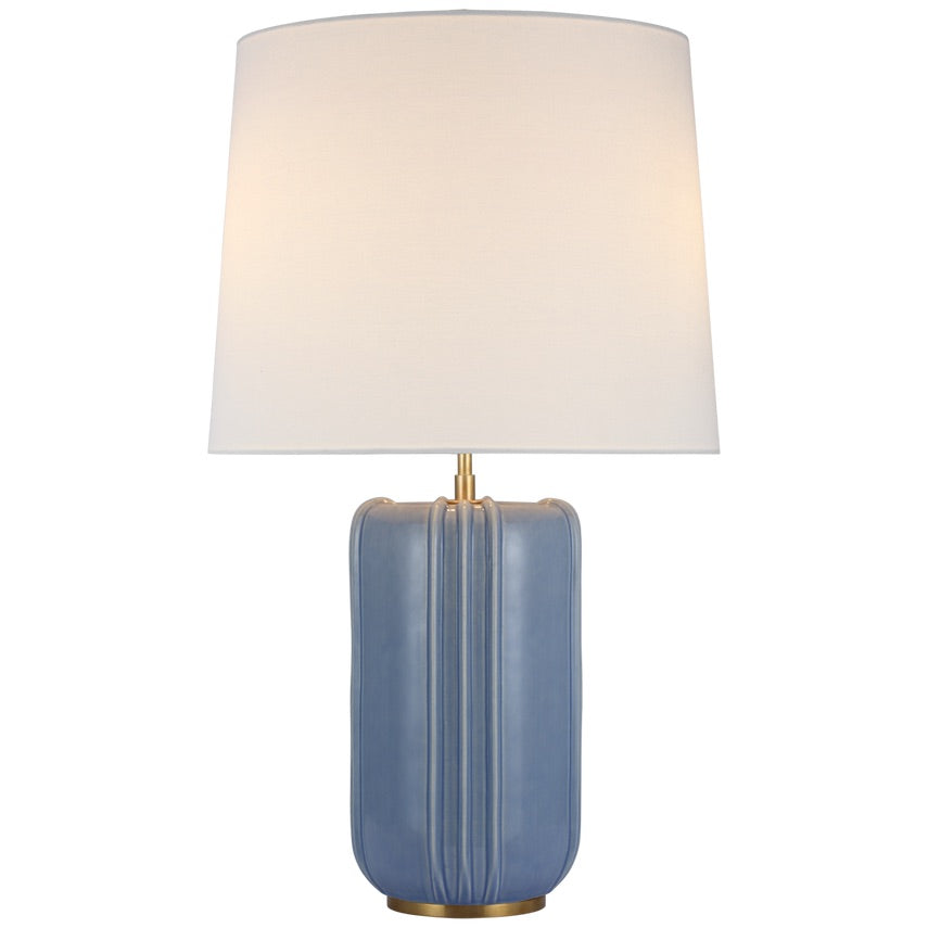 The Visual Comfort Minx Large Table Lamp, featuring mid-century ceramics, boasts a blue ceramic body with a rectangular base and is topped with a white fabric drum shade. Perfect for both modern and traditional rooms.