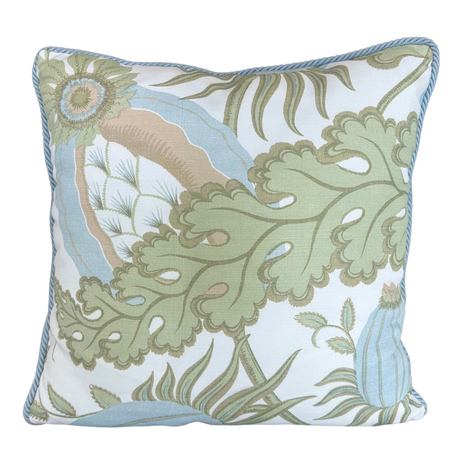 The Associated Design Carnival Celeste Outdoor Pillow features a square shape with a green, blue, and beige botanical pattern on white and piped blue edges, expertly crafted for a luxurious touch.
