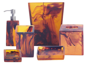 The Nashi Home Tortoise Resin Bath Collection features six amber marbled accessories, including a soap dispenser, tissue box cover, and trays, all inspired by Sydney beaches and shown together on a white background.