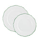 Two white ceramic plates with scalloped edges and a thin green trim from the Raynaud Touraine Green Trim Dinnerware Collection overlap on a plain background, showcasing the brand's delicate porcelain artistry.