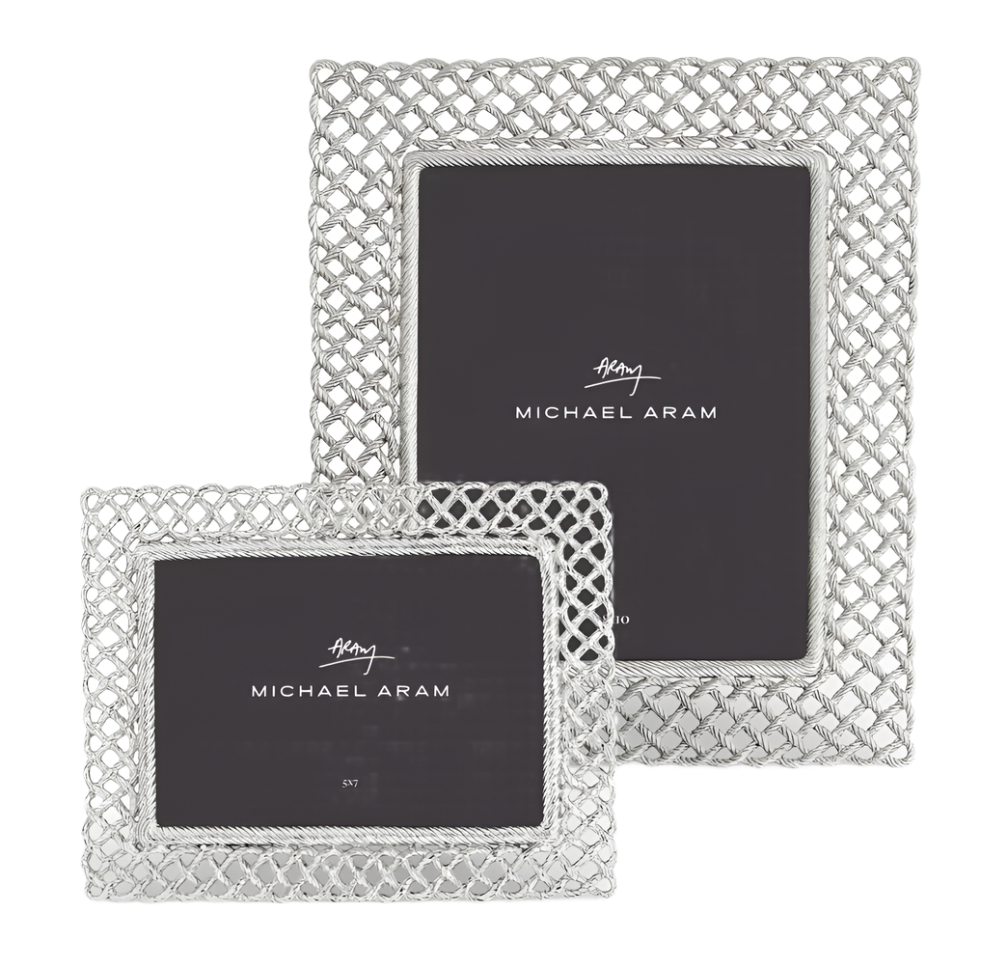 The Michael Aram Love Knot Silver Frame Collection features two silver frames—one rectangular, one square—with open lattice designs, beautifully symbolizing unity and connectedness.