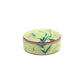 Round, light yellow tin box with a pink rim, featuring floral patterns—an enchanting piece inspired by Italian porcelain from Ginori 1735’s Florenza Impero Dinnerware Collection.