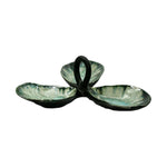 The AE Ceramics Condiment Triple Tray Collection features three green, leaf-shaped ceramic bowls with a central looped handle, ideal for serving condiments or oysters, displayed on a white background.