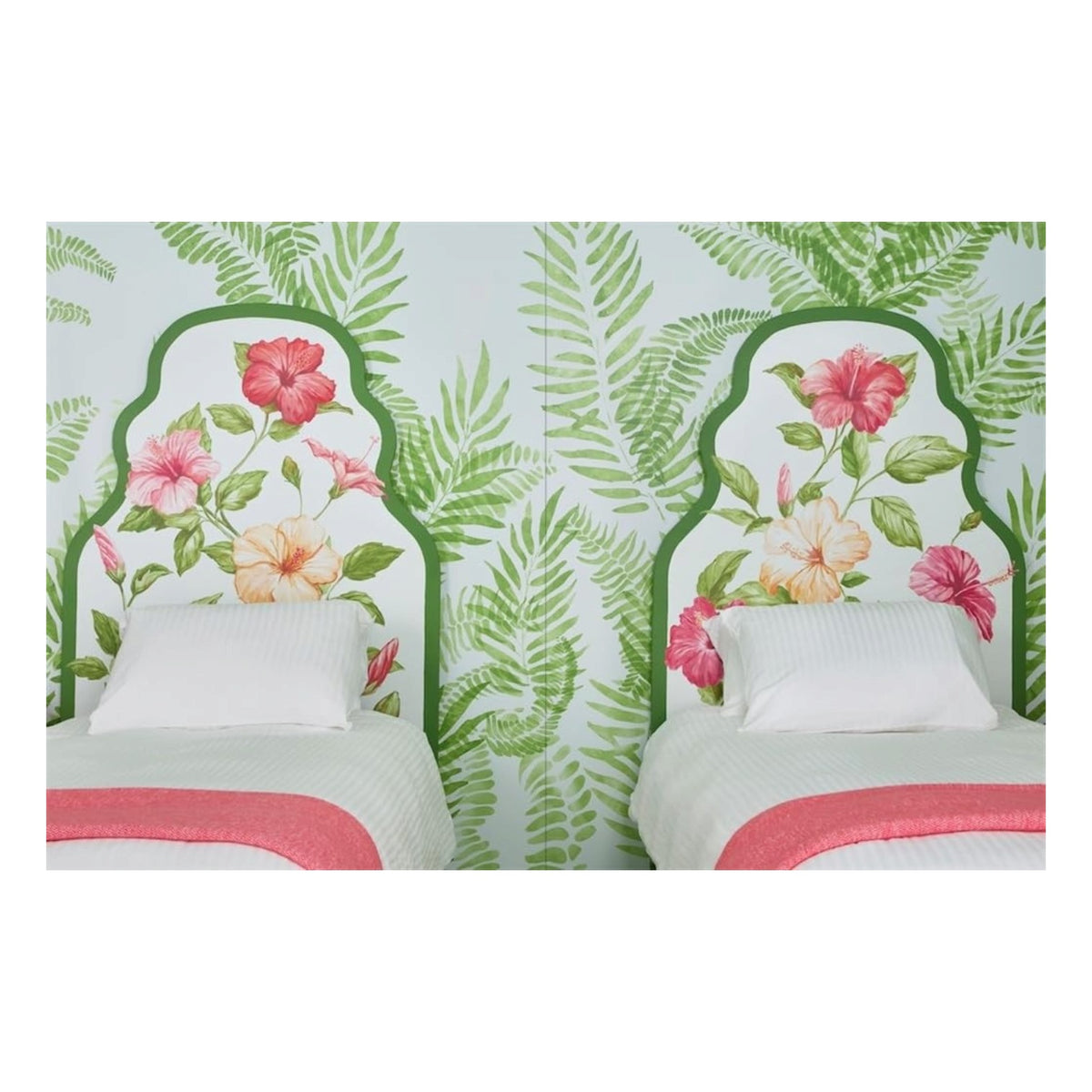 Two twin beds with white linens and coral blankets in the Tropical Living style by Abrams, set against fern wallpaper and hibiscus floral headboards in a tropical-themed room.