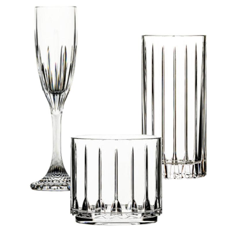 The Tryst Acrylic Drinkware Collection by Bold features a champagne flute, highball, and lowball glass with vertical cut patterns, combining glassware elegance and unbreakable durability—all displayed on a white background.