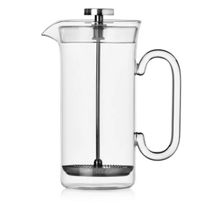The Ichendorf Milano Clarinette Clear French Press, featuring a metal plunger and handle, is elegantly displayed empty against a white background.