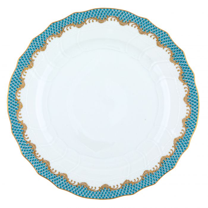 A white hand-painted porcelain plate from the Herend Fish Scale Turquoise Collection, featuring a scalloped edge and a blue and gold patterned border.