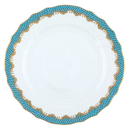 A white hand-painted porcelain plate from the Herend Fish Scale Turquoise Collection, featuring a scalloped edge and a blue and gold patterned border.