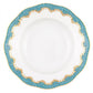 A round white porcelain plate with a textured center and a scalloped rim featuring blue and gold patterns, inspired by Herend's Fish Scale Turquoise Collection.