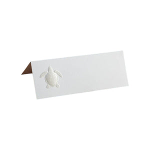 The Printery Turtle Place Card Set features pearl white folded cards with an embossed turtle design on the left side—a refined choice for elegant wedding place settings.