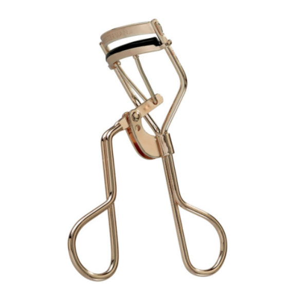 The Tweezerman Curl 38 Eyelash Curler is a gold metal curler with black rubber padding, designed to enhance almond-shaped eyes, shown against a white background.