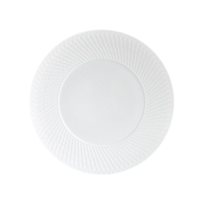 A plate from the Bernardaud Twist White Collection, featuring a textured geometric rim inspired by Japanese design, is shown from above against a plain white background.