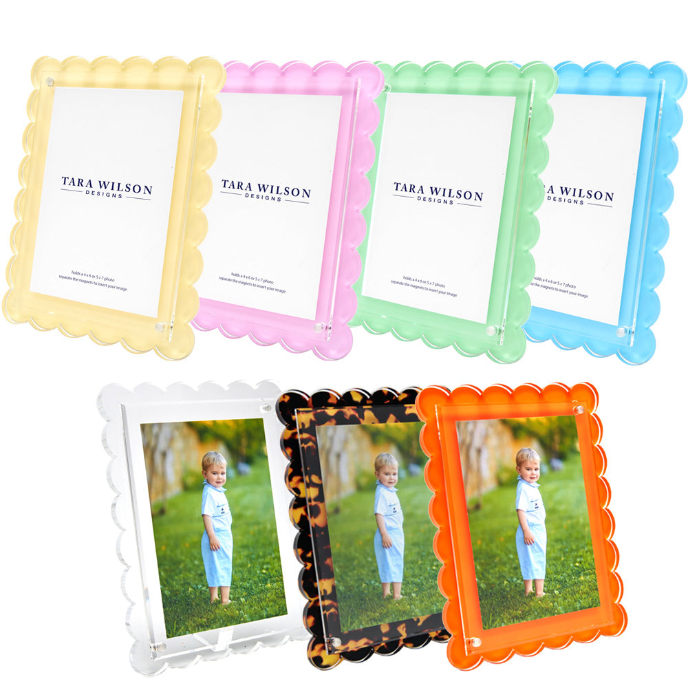 Seven colorful frames from the Tara Wilson Designs Scallop Frame Collection are shown—two with child photos, others with brand inserts. These best-seller frames bring a playful touch to any space.